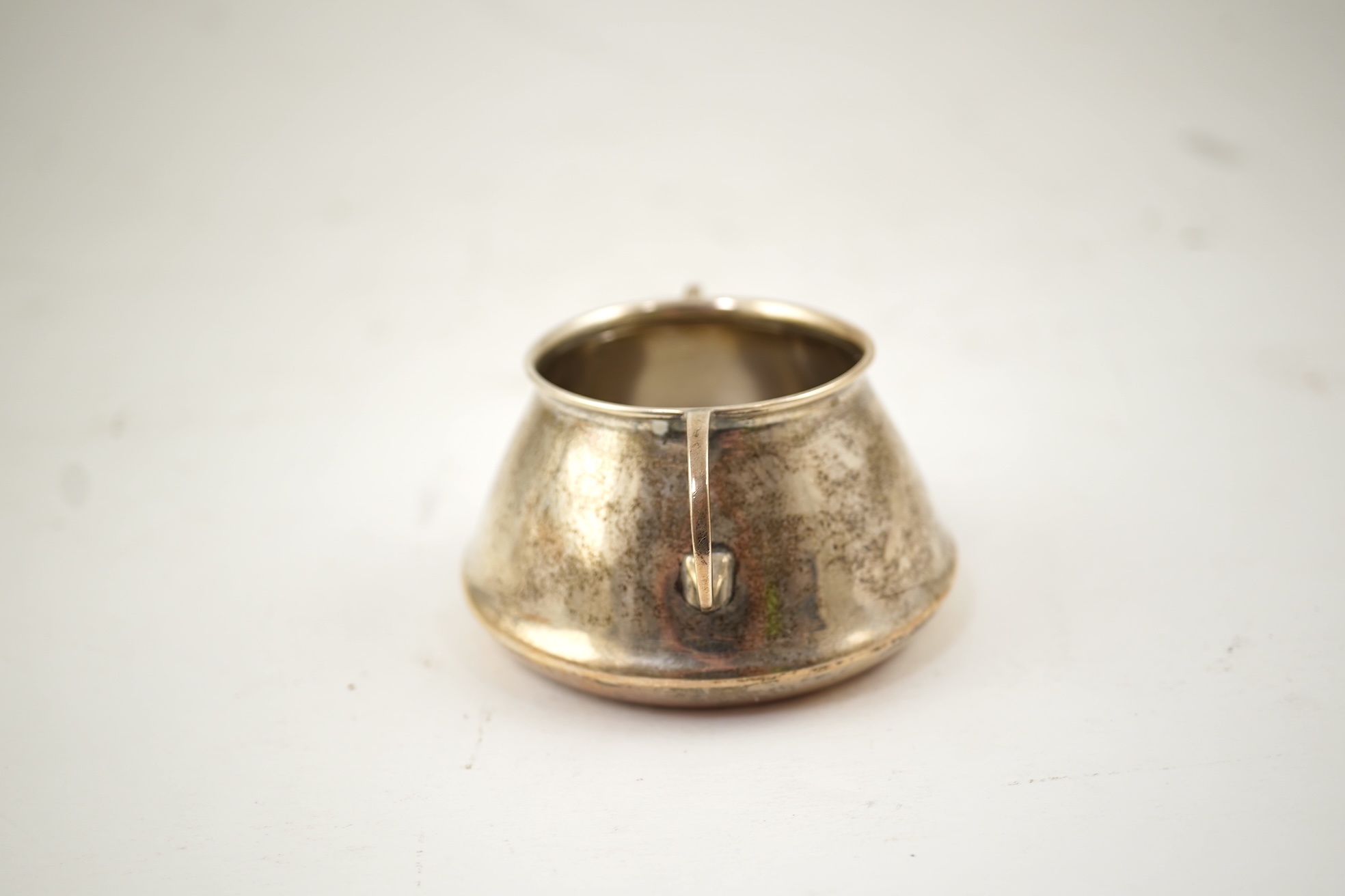 An Edwardian silver bachelor's two handled sugar bowl and matching sugar tongs, by Liberty & Co